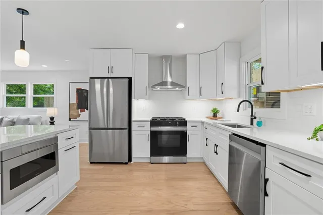 a kitchen with stainless steel appliances and white cabinets