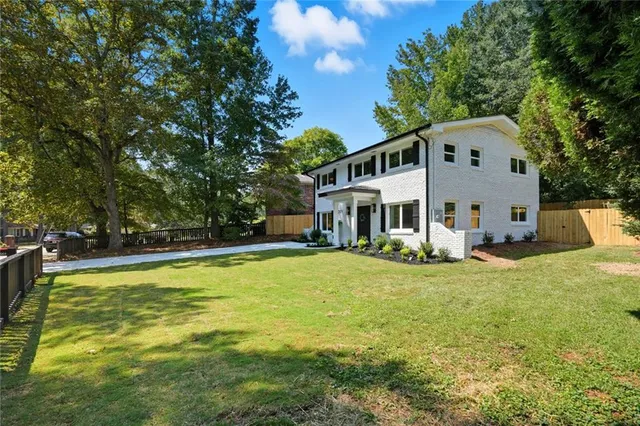 a front view of a house with a yard table and chairs