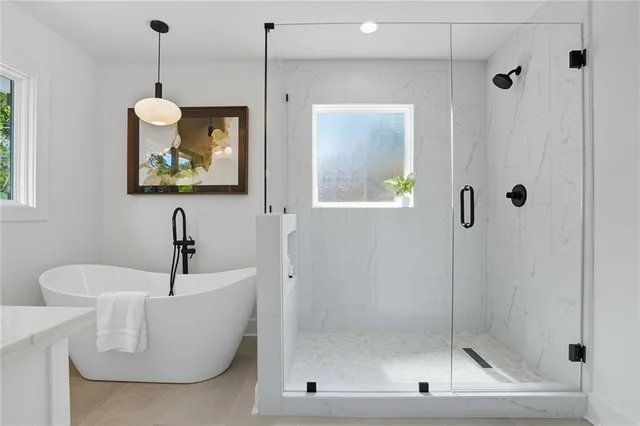 a bathroom with a bathtub and a window