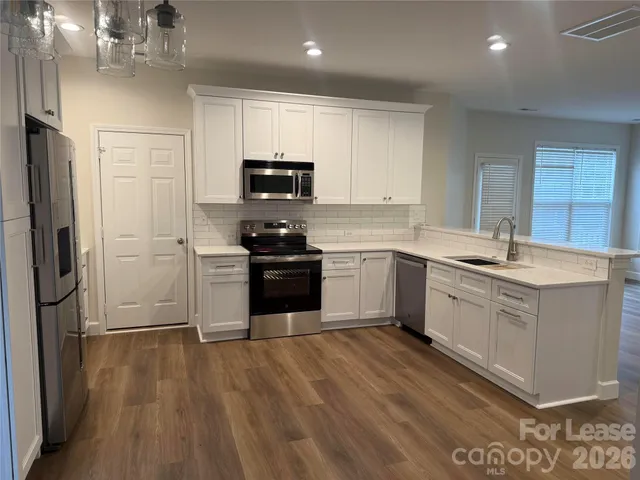 a kitchen with a white cabinets and stainless steel appliances