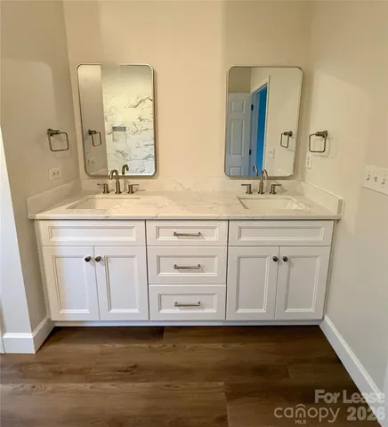 a bathroom with a sink vanity and mirror