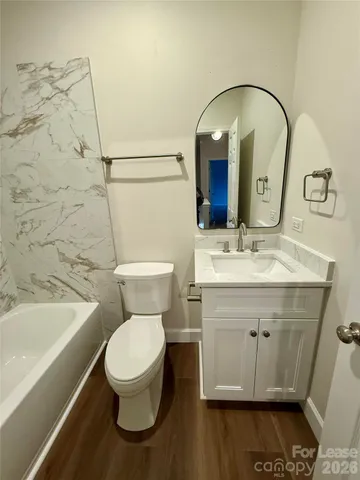 a view of an empty room with a fireplace and a window
