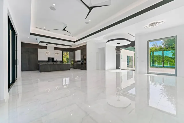 an aerial view of residential houses with outdoor space and trees all around