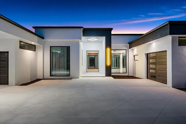 a large kitchen with kitchen island a large window a sink and stainless steel appliances