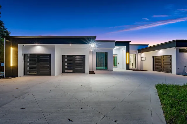 a large kitchen with granite countertop a sink and a stove
