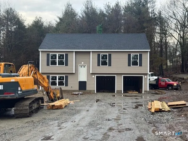 a backyard of a house with parked cars and trees