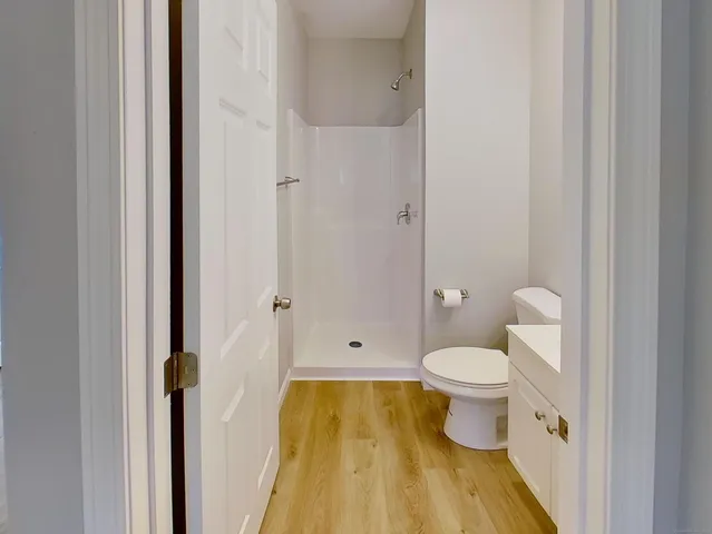 a bathroom with a toilet and a shower