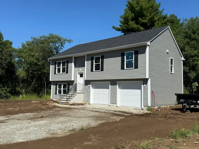 a house that has a tree in front of it