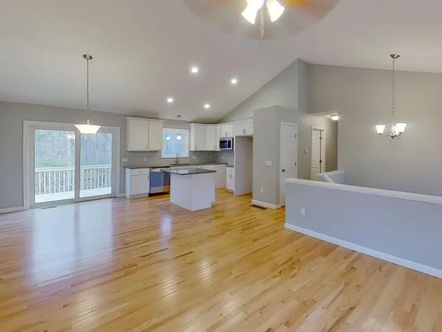 a view of kitchen with wooden floor and stainless steel appliances