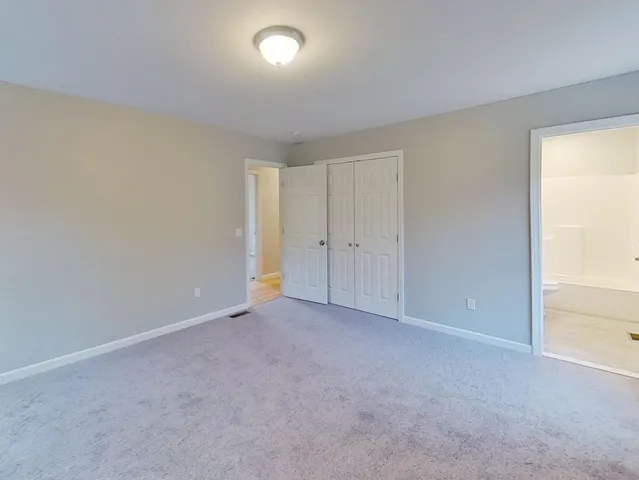 an empty room with closet area