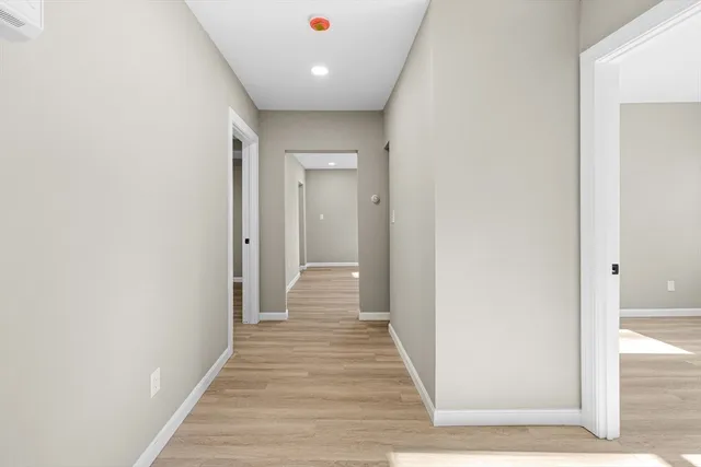 a view of a hallway with wooden floor