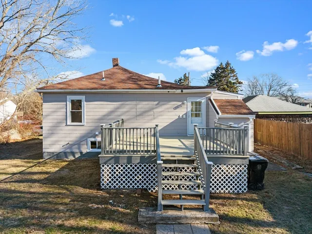 a view of a brick house with wooden fence