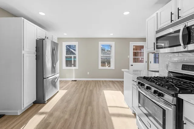 a kitchen with stainless steel appliances granite countertop a stove and a refrigerator