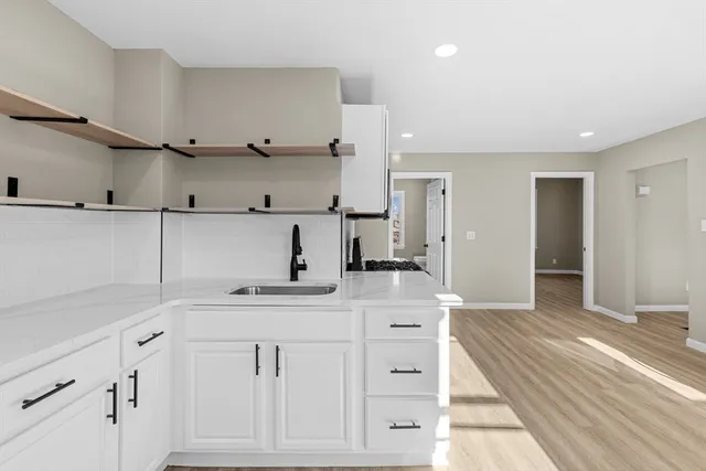 a view of cabinets a sink and dishwasher in a kitchen