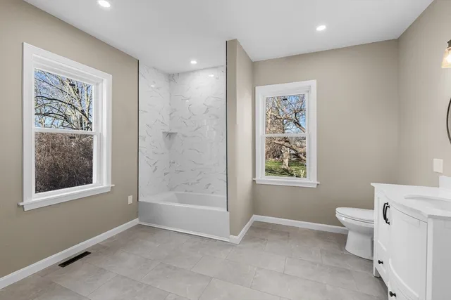 a bathroom with a toilet sink and shower