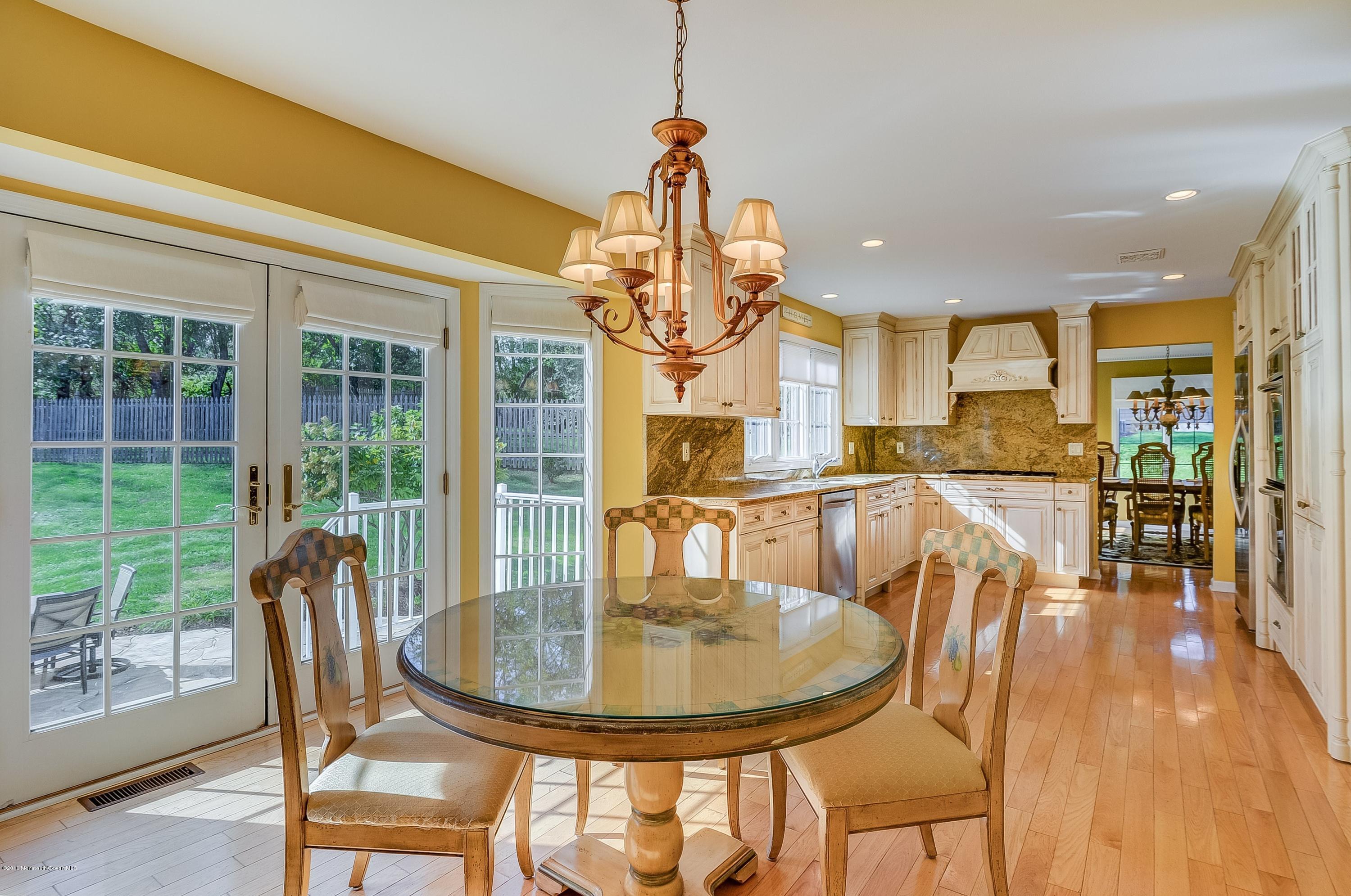 490 Burlington Road Freehold, NJ 07728 - Photo 15 of 34 a view of a dining room with furniture wooden floor and a chandelier