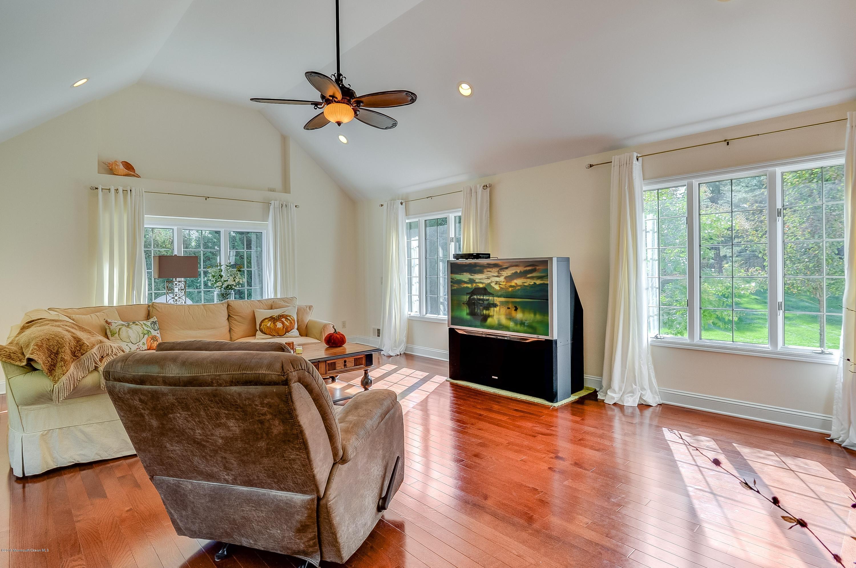 490 Burlington Road Freehold, NJ 07728 - Photo 18 of 34 a living room with furniture and a flat screen tv