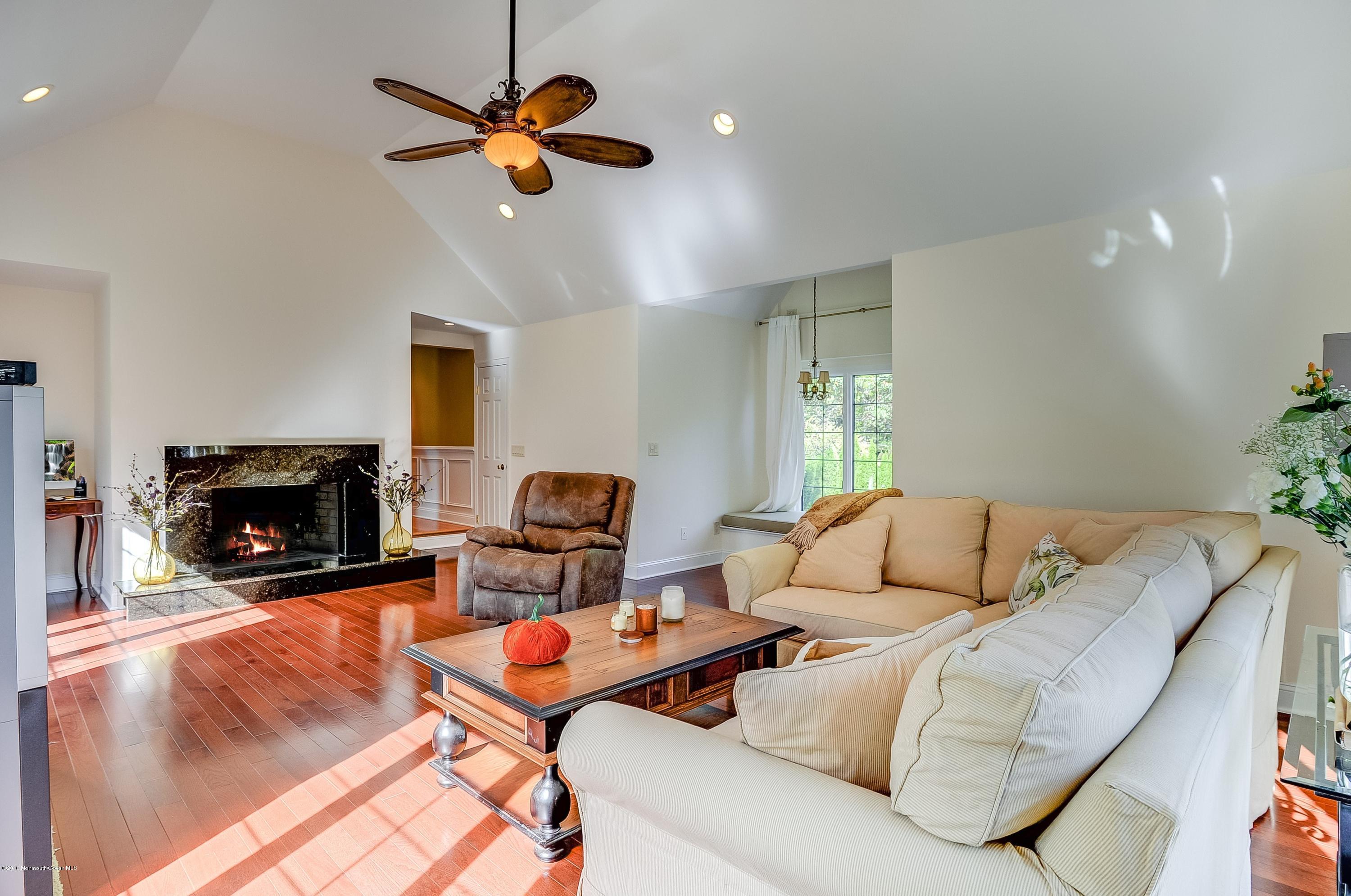 490 Burlington Road Freehold, NJ 07728 - Photo 20 of 34 a living room with furniture and a fireplace