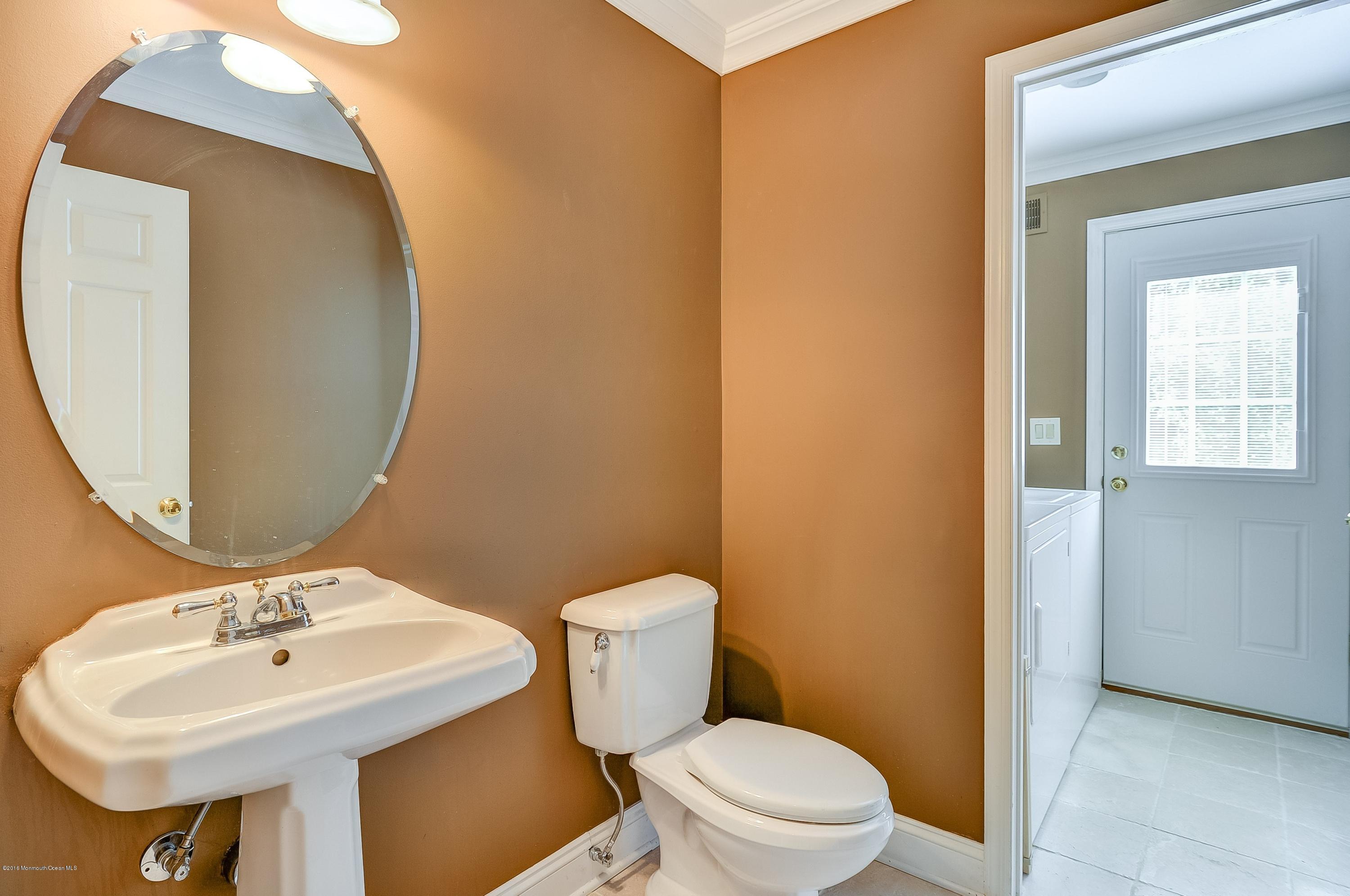 490 Burlington Road Freehold, NJ 07728 - Photo 21 of 34 a bathroom with a sink mirror and toilet