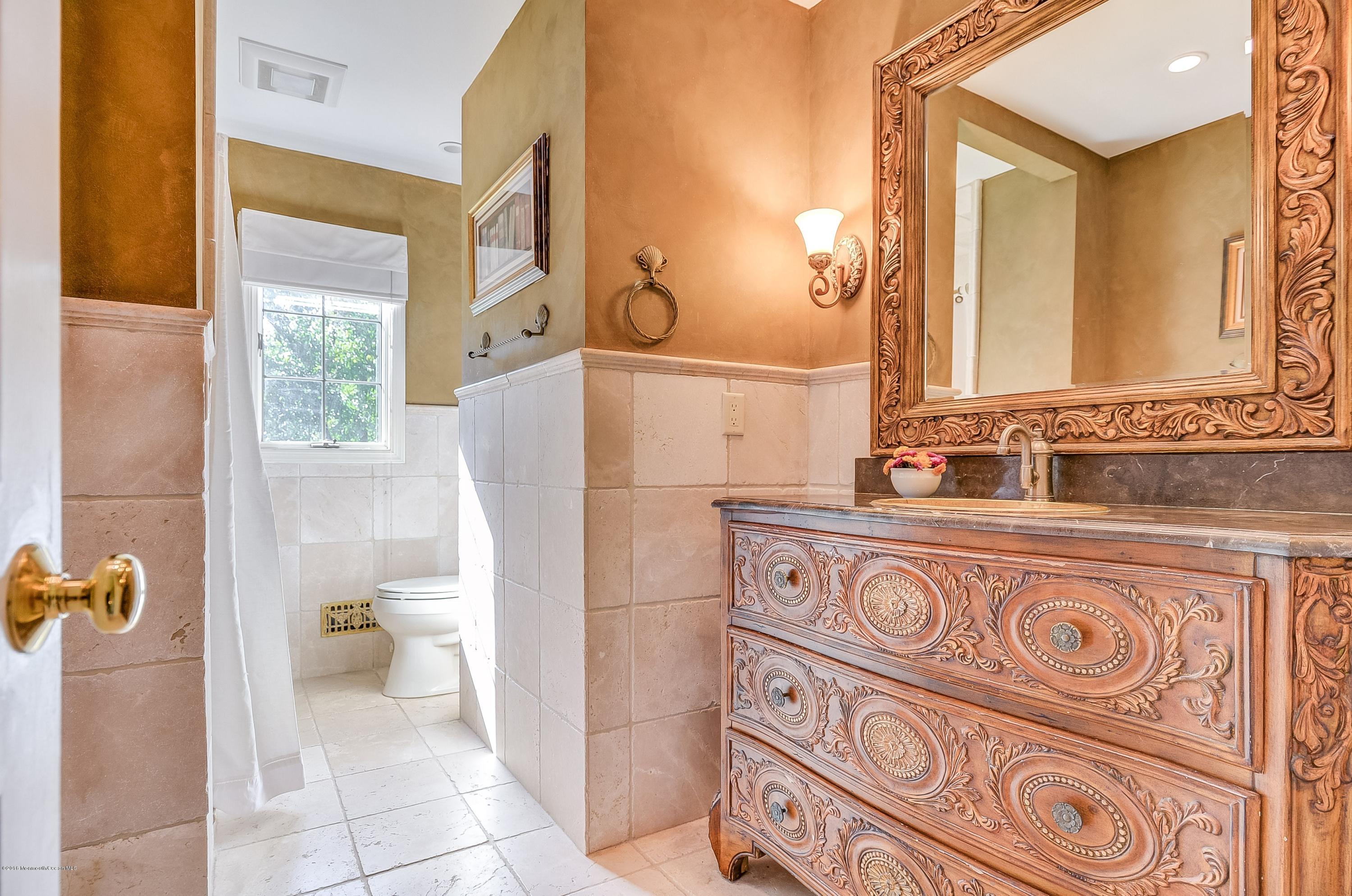 490 Burlington Road Freehold, NJ 07728 - Photo 29 of 34 a bathroom with a sink a toilet and a mirror
