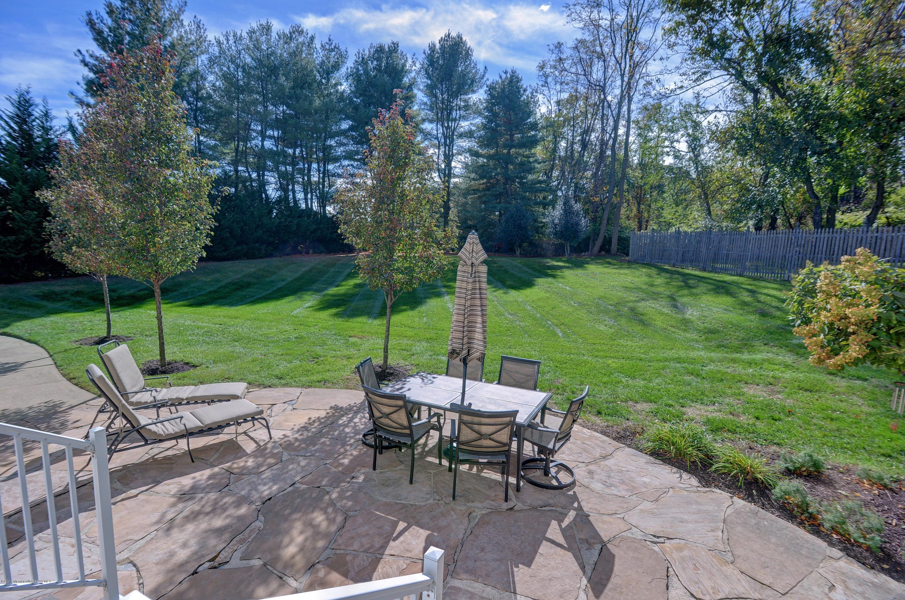 490 Burlington Road Freehold, NJ 07728 - Photo 31 of 34 a view of a table and chairs in the backyard