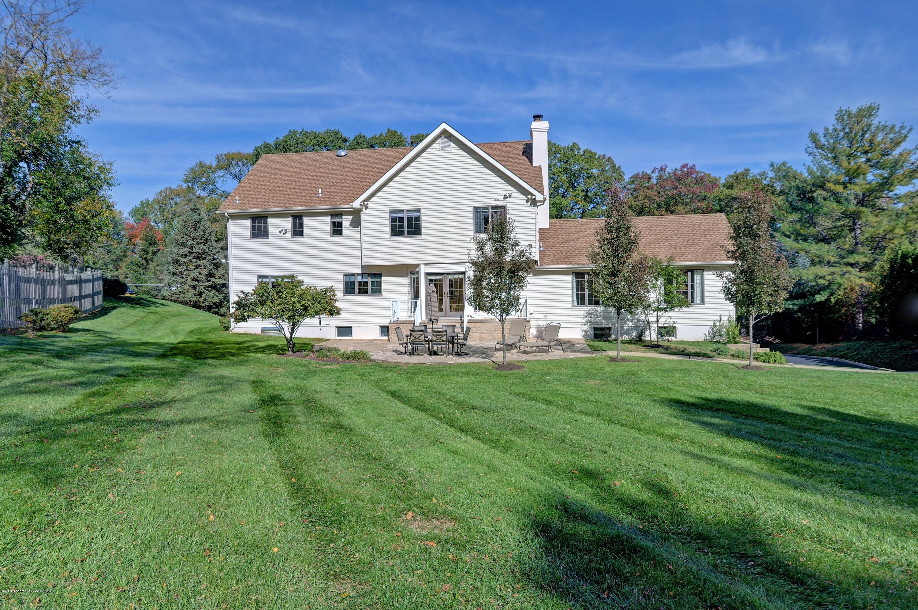 490 Burlington Road Freehold, NJ 07728 - Photo 32 of 34 a front view of a house with a yard porch and outdoor seating