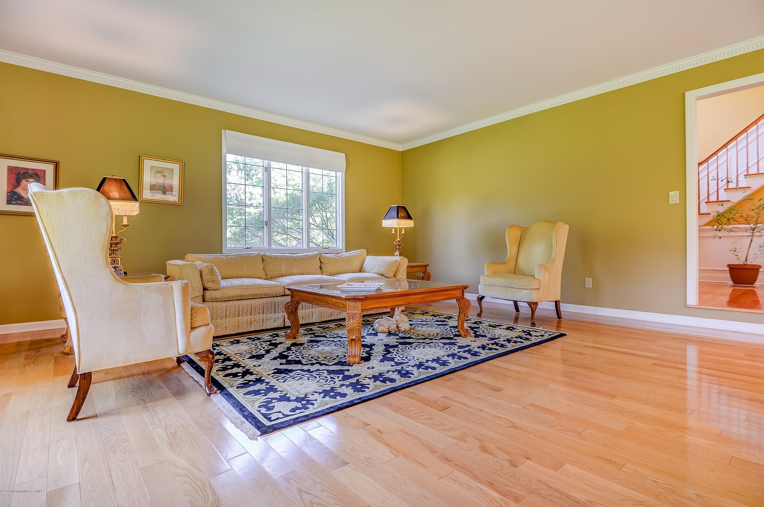 490 Burlington Road Freehold, NJ 07728 - Photo 8 of 34 a living room with a couch and a table