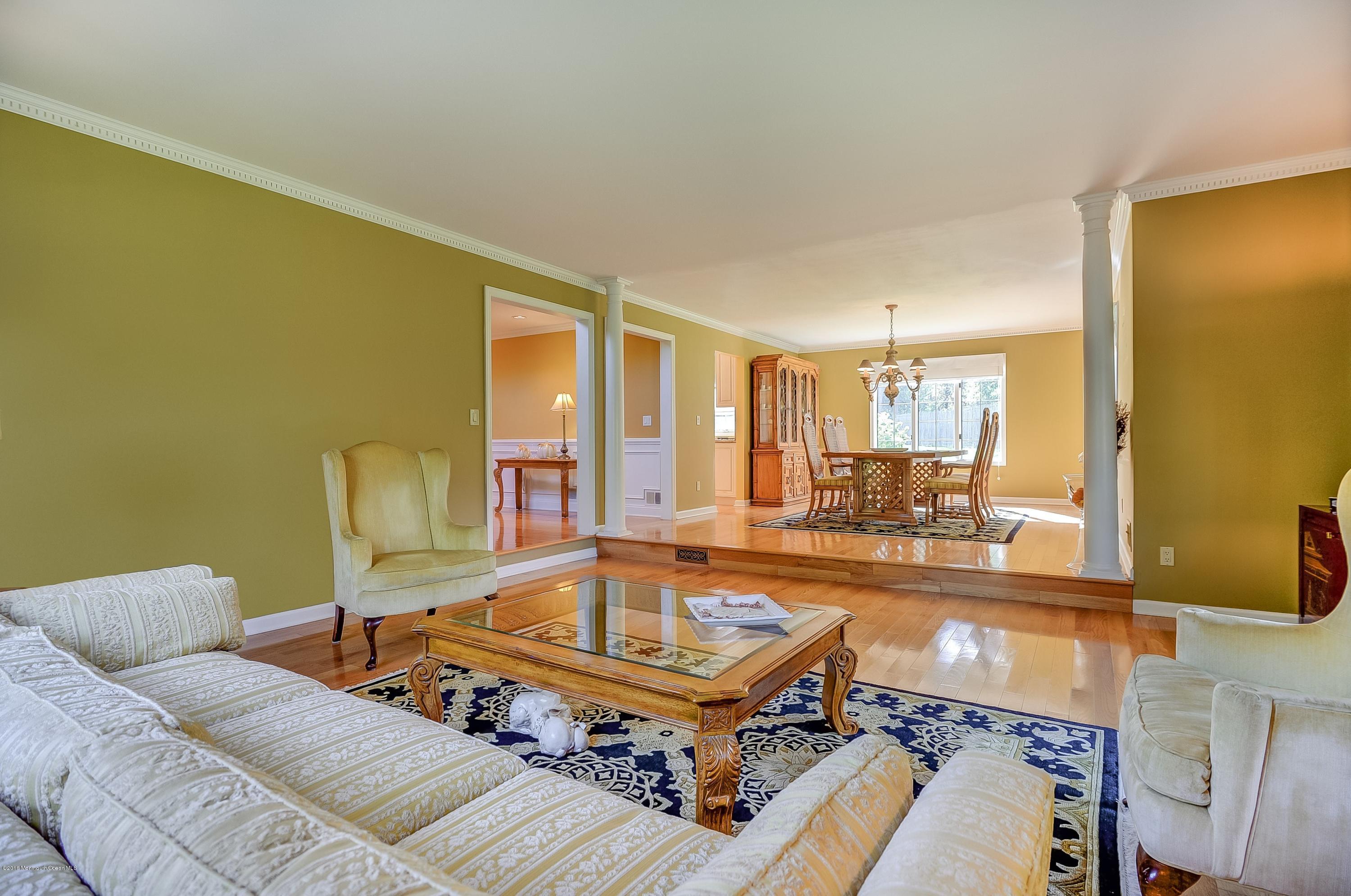 490 Burlington Road Freehold, NJ 07728 - Photo 9 of 34 a living room with a couch and a table