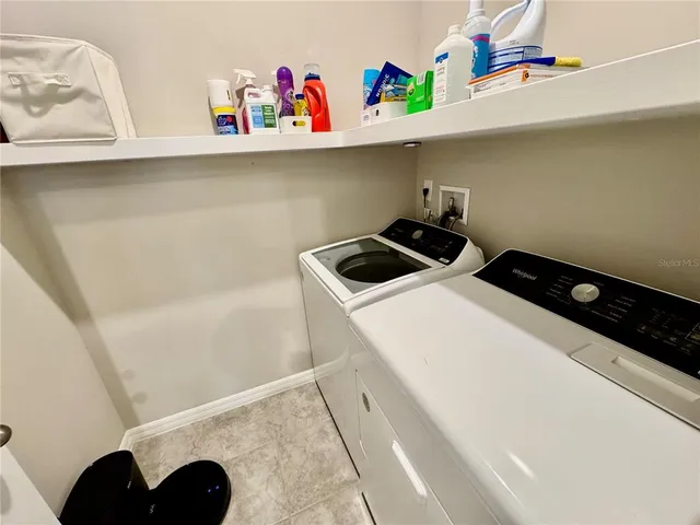 a bedroom with a bed couch and a window