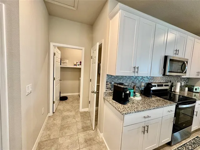 a spacious bathroom with a toilet sink and mirror