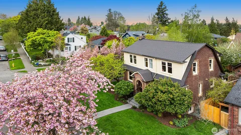 a aerial view of a house with a yard and potted plants