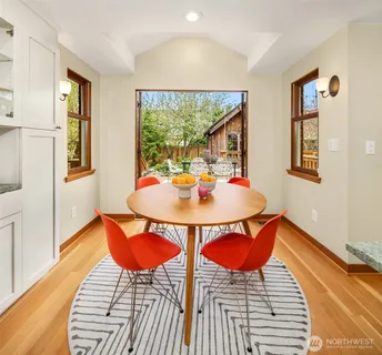 a dining room with furniture and wooden floor
