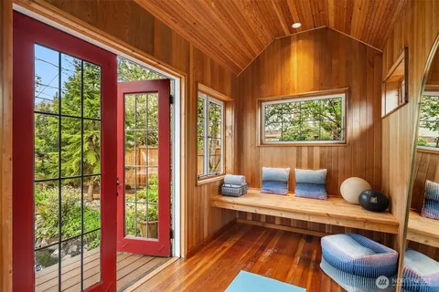 a view of living room with wooden floor and a fireplace