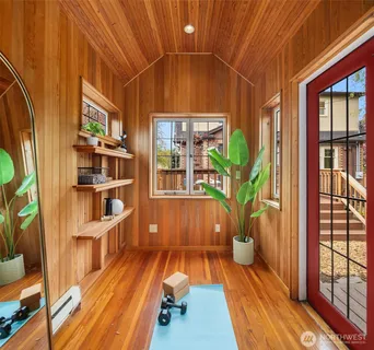 a bedroom with a bed wooden floor and window
