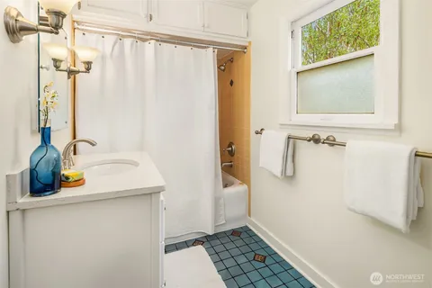 a utility room with cabinets washer and dryer
