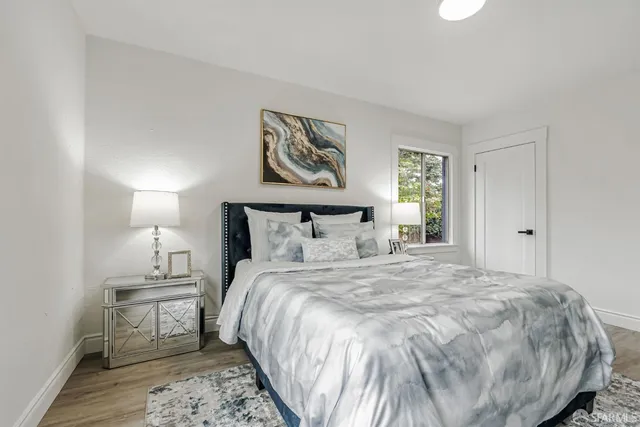 a bedroom with a bed and a night stand