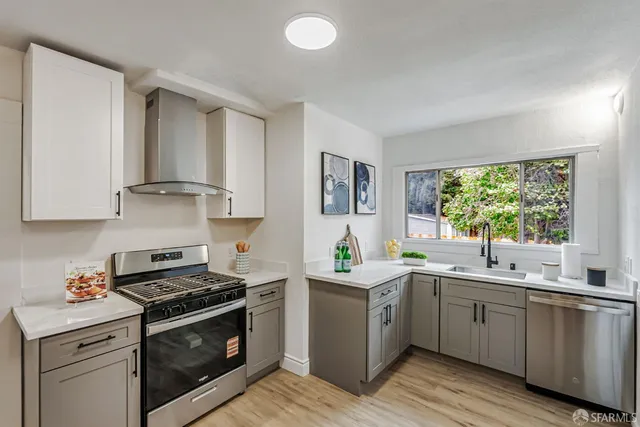 a kitchen with granite countertop a stove a sink dishwasher and a refrigerator