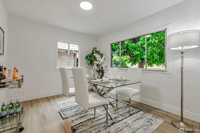 a view of a dining room with furniture window and wooden floor