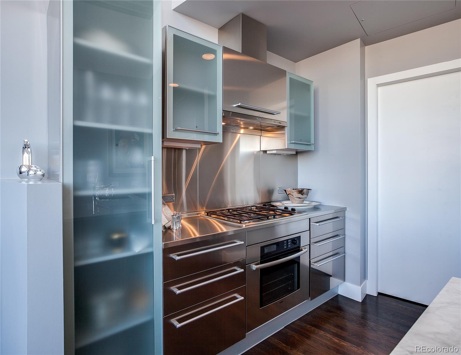 1200 Acoma Street, Unit 603 Denver, CO 80204 - Photo 14 of 30 a stove top oven sitting inside of a kitchen