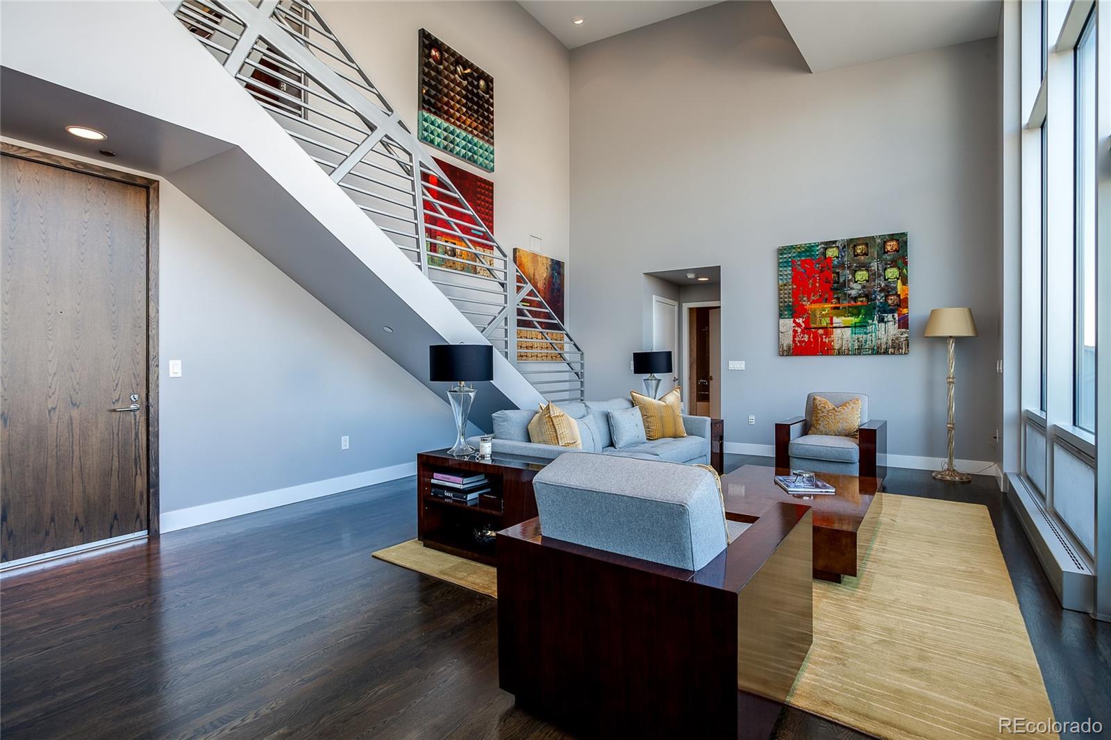 1200 Acoma Street, Unit 603 Denver, CO 80204 - Photo 10 of 30 a living room with couches and painted walls with wooden floor