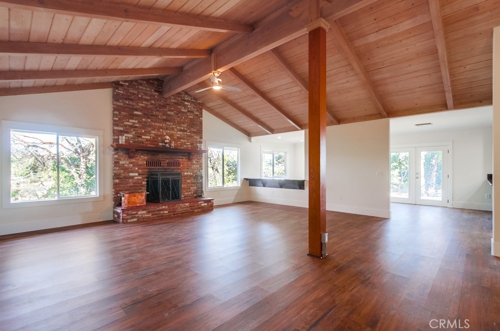 3927 Valle Del Sol Bonsall, CA 92003 - Photo 11 of 41 a view of empty room with wooden floor and fireplace