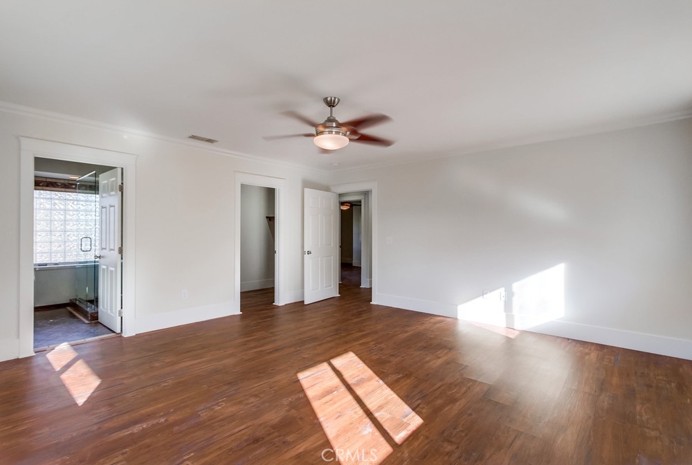 3927 Valle Del Sol Bonsall, CA 92003 - Photo 15 of 41 a view of a big room with wooden floor and a ceiling fan
