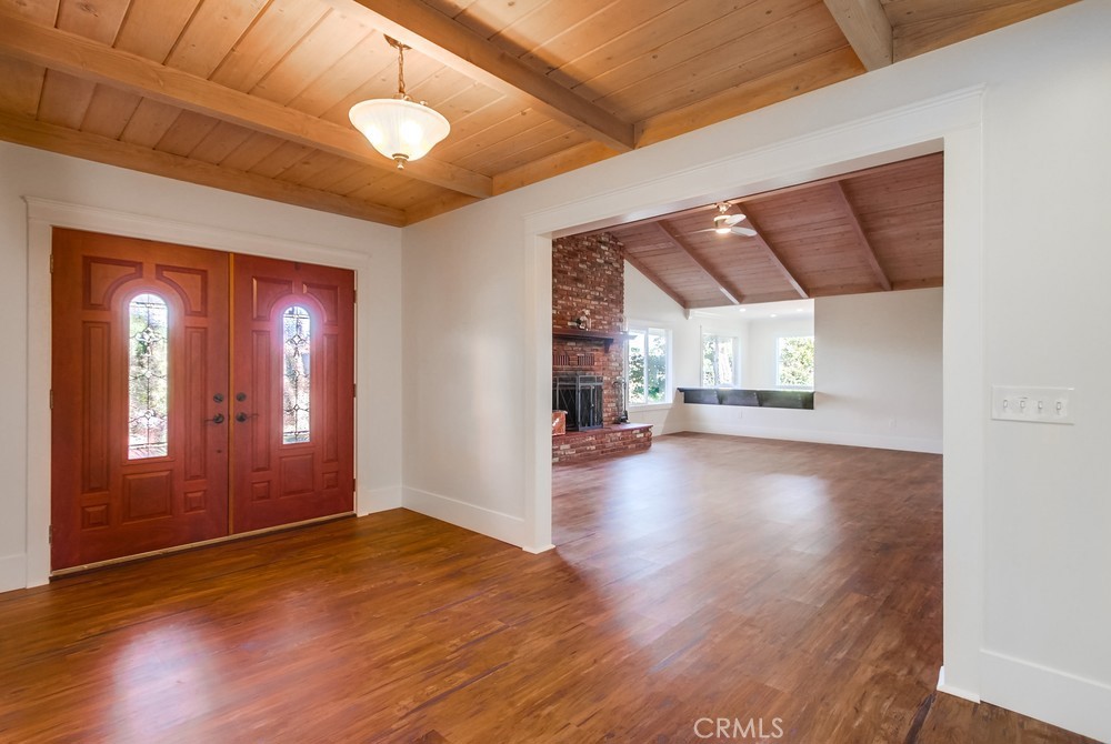 3927 Valle Del Sol Bonsall, CA 92003 - Photo 6 of 41 a view of a livingroom with wooden floor and a ceiling fan