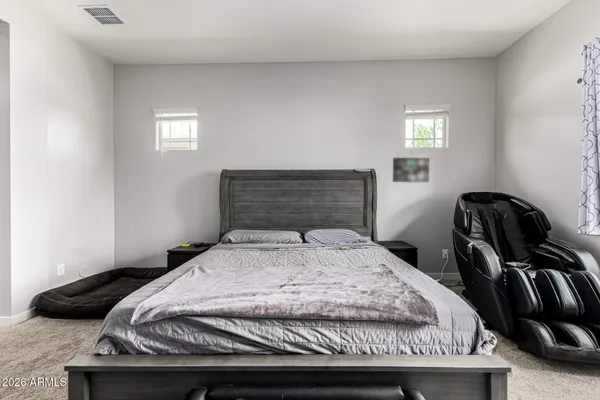 a bedroom with a bed and a television