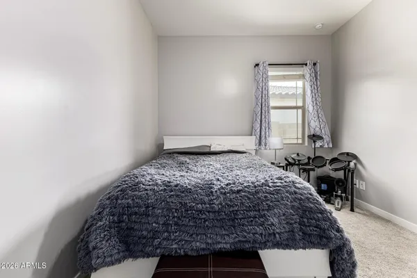 a bedroom with a bed and a window