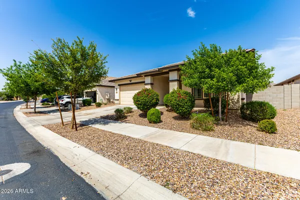 a view of a house with a yard and sitting area