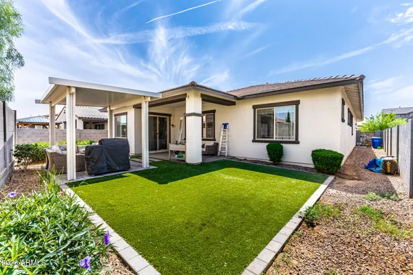 a backyard of a house with table and chairs