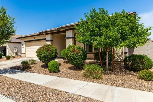 a sign board with a house in the background
