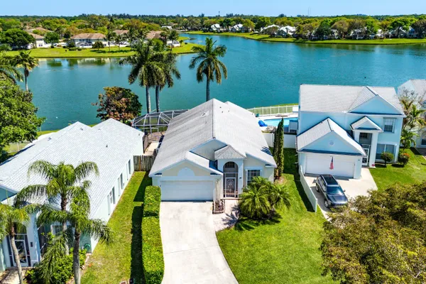 an aerial view of a house with a lake view