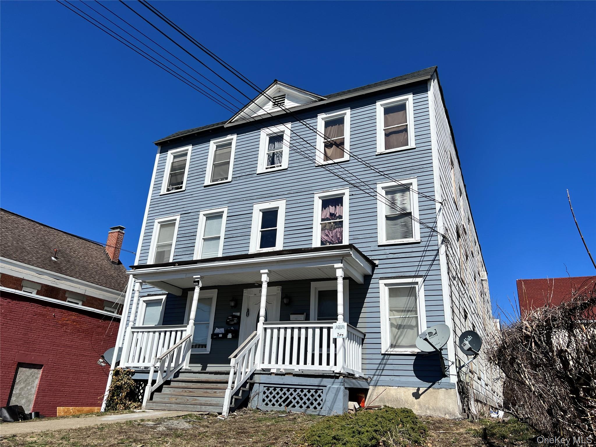 761 Main Street, Unit 3E Poughkeepsie, NY 12603 - Photo 1 of 8 a front view of a house with a garden